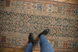 Malayer runner's repeating germinating plant and diamond motifs in muted teal, terracotta, and beige tones.