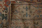 Hand-knotted foundation showing wear and geometric pile of an antique Malayer rug.
