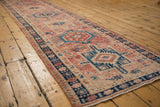 Distressed vintage Karaja runner section showing blush, navy geometric florals, boteh motif, and pile wear.