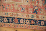 Distressed vintage Karaja runner showcasing blush, navy, and beige geometric floral borders.