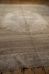 Abrashed sand and ivory short pile texture of a distressed vintage Oushak rug.