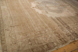 Abrashed sand and pale blush field with interconnected pomegranate border on distressed Oushak.