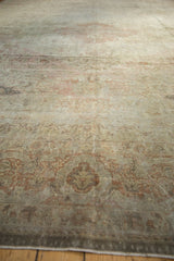 Distressed Sivas carpet pile, showing muted ivory and dusty rose floral patterns.