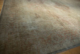 Distressed vintage Sivas carpet displaying low pile and soft dusty rose quatrefoil palmettes and border.