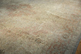 Distressed Sivas carpet displaying faded floral patterns, worn texture, and muted ivory, rose, silver.