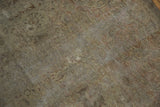 Detailed texture of a distressed vintage Sivas carpet, showcasing faded ivory and rose floral motifs.