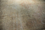 Distressed Sivas carpet, textural weave with faded floral motifs in ivory and dusty rose.