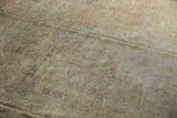 Distressed pile of the Sivas carpet with muted ivory and dusty rose floral motifs.
