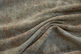 Distressed Sivas carpet detail: soft texture, faded ivory, and dusty rose with visible knot heads.