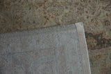 Hand-knotted foundation and secured selvage edge of the distressed Sivas carpet's faded pile.
