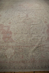 Distressed Sivas carpet detail with muted dusty rose floral motifs and border.