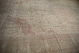 Vintage distressed Sivas carpet border with faded dusty rose and ivory floral motifs.