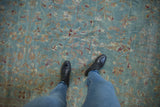 Distressed vintage Meshed carpet with faded powder blue field, delicate vinery, and floral motifs.