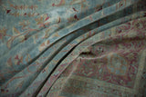Distressed pile of vintage Meshed carpet with delicate vinery in powder blue and wine red.