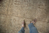 Distressed Karaja carpet with visible even wear, highlighting geometric and soft palmette gul motifs.