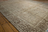 Distressed vintage Karaja carpet showing muted silver and chocolate palmette motifs.