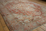 Distressed Heriz carpet texture showcasing geometric botehs, floral patterns, and softened red, dusty blue, ivory tones.