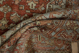 Distressed Heriz rug detail: even wear, geometric pattern, deep red, dusty blue.
