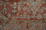 Distressed texture and geometric patterns in deep red, ivory, and muted blue.
