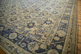Distressed Oushak carpet corner with cobalt blue floral border and ivory floral field.