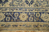 Distressed Oushak carpet border in cobalt blue and antique ivory, with visible knot head wear.