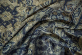 Oushak rug close-up showing soft low pile, faded cobalt blue and ivory floral design.