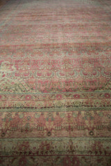 Vintage Distressed Kerman carpet's millefleur and vase motifs with even wear in pale raspberry, ivory, and blue.