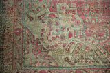 Close-up of Vintage Distressed Kerman carpet, displaying even wear on raspberry, ivory, dusty blue millefleur.
