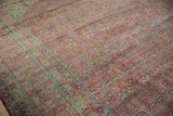 Distressed Kerman carpet with raspberry blush, dusty blue millefleur pattern and visible even wear.