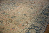 Distressed dusty blush field featuring floral motifs and a dusty navy border.