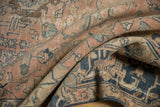 Distressed vintage Tabriz carpet with faded dusty blush, navy, ivory palmettes, and arabesques.