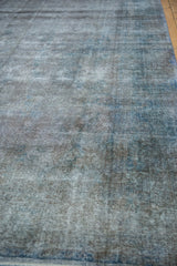 Distressed texture of a vintage Turkish Sparta carpet with silver and dusty cobalt blue tones.