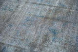 Distressed texture of vintage Sparta carpet with oxidized silver and dusty cobalt blue.