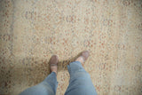 Distressed vintage Kayseri carpet with faded ivory, blush, and pale blue floral lattice.