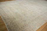 Distressed vintage Kayseri carpet corner with worn ivory field and pale blue boteh border.