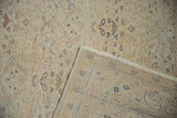 Vintage distressed Kayseri carpet showing pale floral pile, reverse foundation, and fringe.