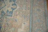 Close-up of distressed Oushak pile, showing geometric blossoms, even wear, and pale blue border.