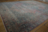 Corner detail of distressed Persian Khorossan rug, soft fringe, and Safavid-inspired border.