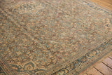 Distressed Hamadan carpet's geometric Herati design showing worn texture in apricot and blue.