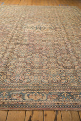 Distressed vintage Hamadan border, geometric patterns in dusty apricot, blue, and sand, with even wear.