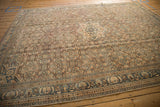 Distressed Hamadan rug border, faded geometric motifs in blue, apricot, showing even pile wear.