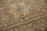 Distressed geometric Herati motif in dusty apricot, blue, and sand hues.