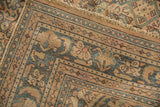 Vintage Hamadan carpet corner, geometric border in dusty blues, apricots, with textured wear.