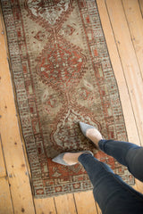 Close-up of distressed vintage Serab runner's wear, highlighting geometric latch and hook motifs.