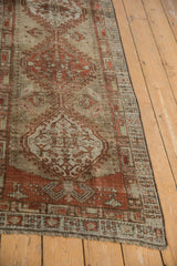 Distressed vintage Serab rug runner with faded chestnut medallion and geometric motifs.
