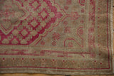 Vintage Distressed Khotan runner close-up, faded cochineal red, antique ivory, worn pile and plant border.
