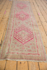 Vintage Khotan runner end, with fringe and distressed raspberry red geometric pattern.