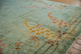 Saffron and blush floral vinery with bamboo motifs on the sea foam green Art Deco rug.