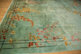 Blush, saffron, and copper floral bouquets with bamboo on a sea foam green Art Deco rug.