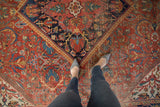 Vintage Mahal carpet: elaborate scrolling floral patterns in brick red, sapphire blue, and gold.